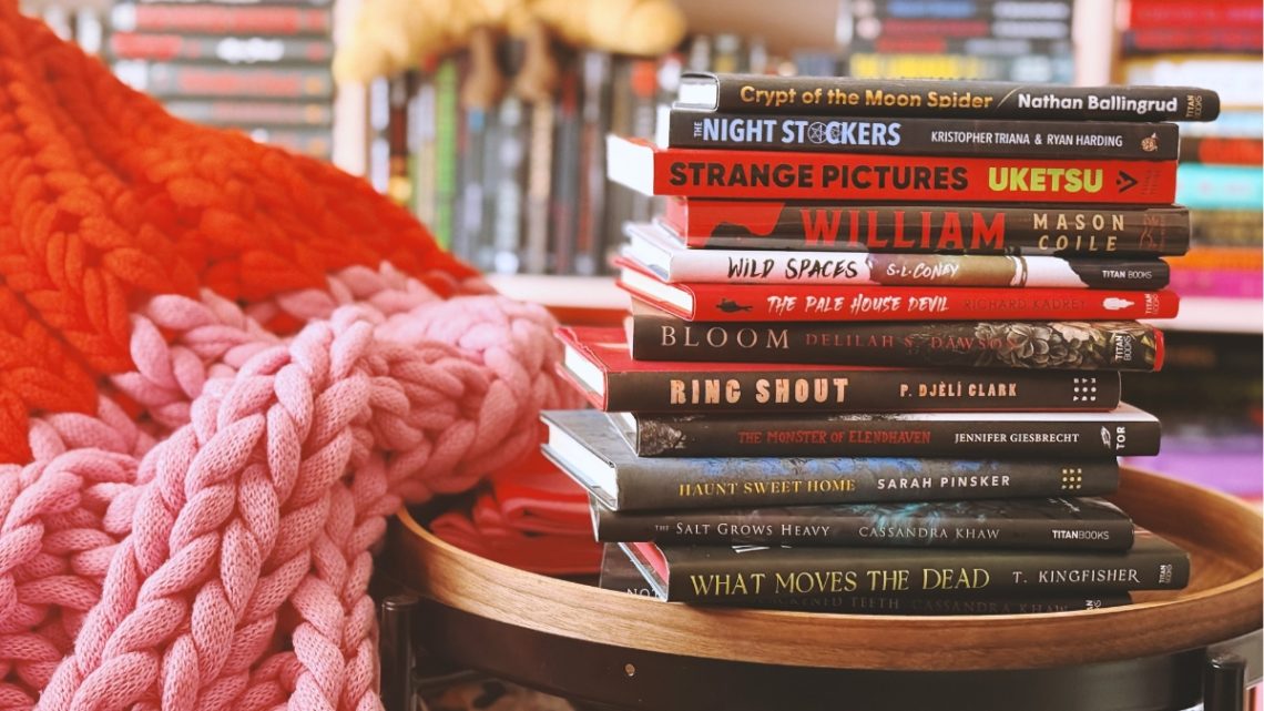 12 books stacked on a side table