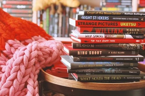 12 books stacked on a side table